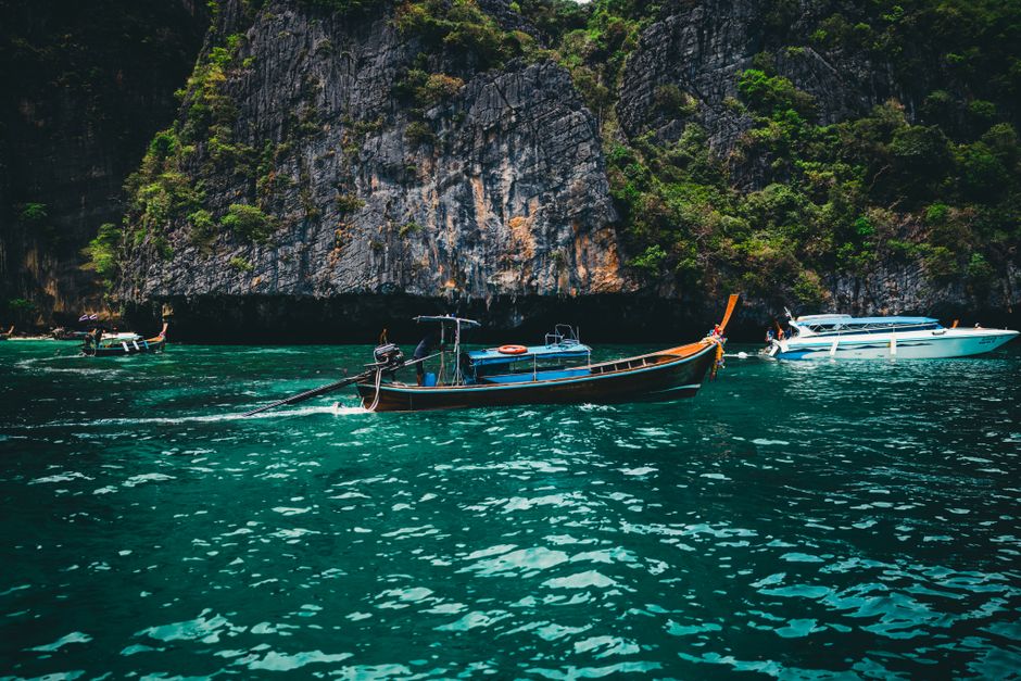Explore Phuket's stunning limestone cliffs and clear waters onboard traditional long-tail boats.