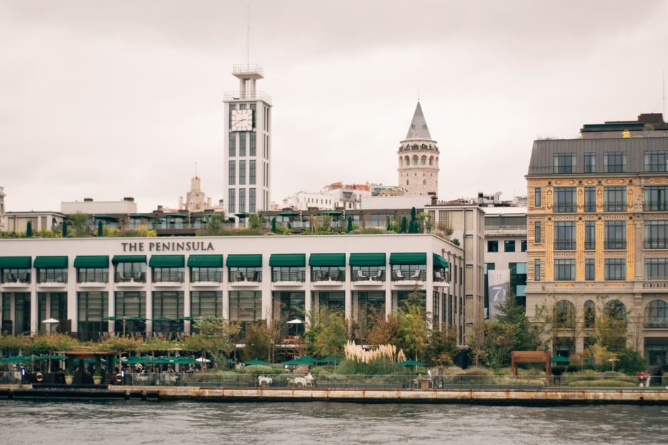 View of Galata Tower and The Peninsula Hotel from the Bosphorus in Istanbul, Turkey.