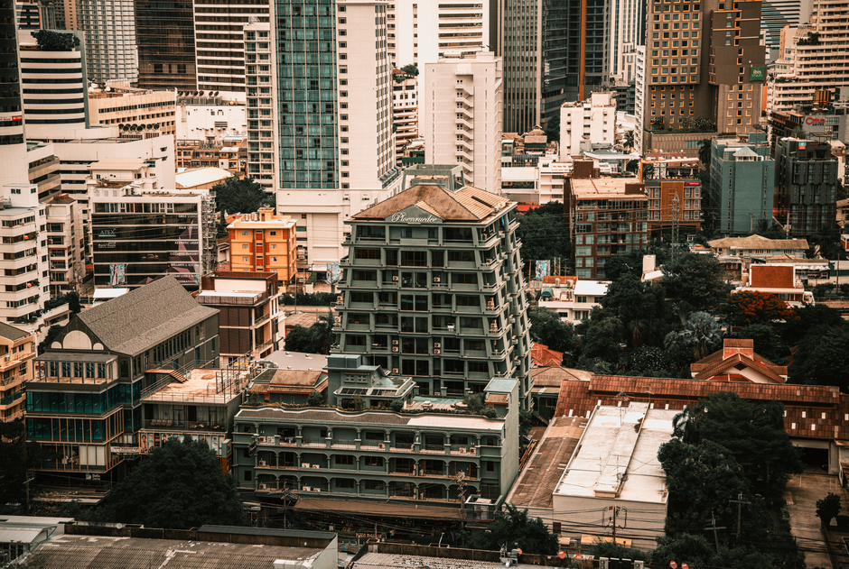 Aerial view showcasing the diverse architecture of Bangkok, Thailand's skyline with modern and classic buildings.