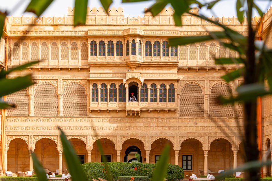 Stunning view of ornate Rajasthani architecture with a folk musician in Jaisalmer, India.
