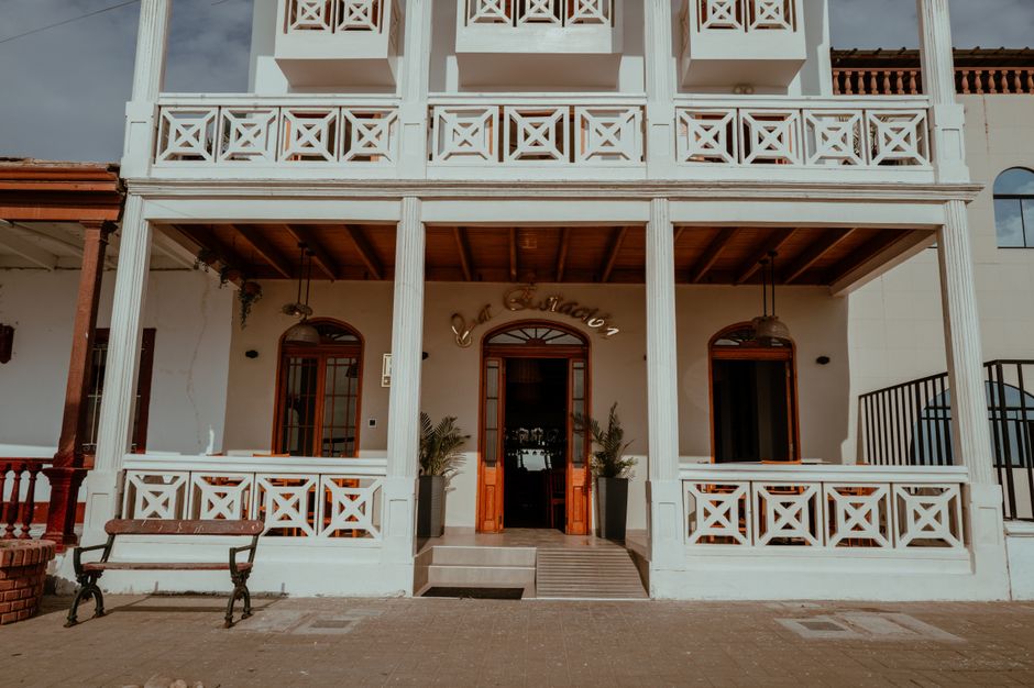 Beautiful colonial-style building facade in Pacasmayo, Peru, showcasing intricate wooden details and classic design.