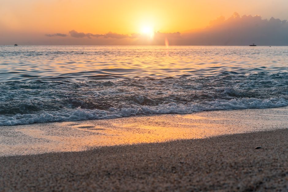 Beautiful sunset at Alanya beach, Turkey, with golden light reflecting on the waves.