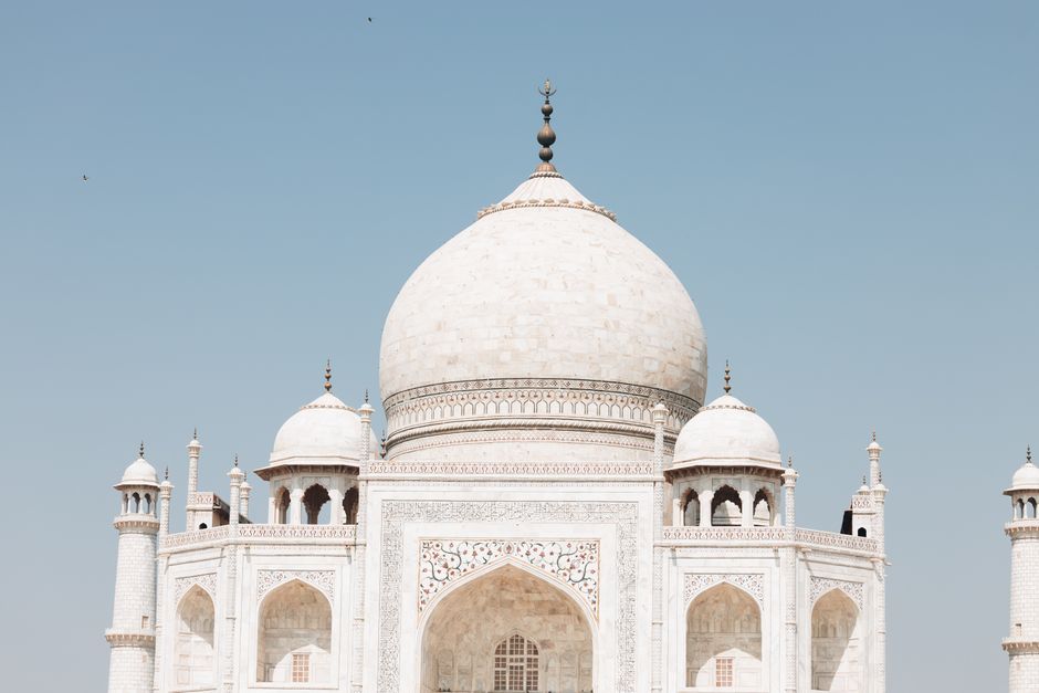 Close-up view of the iconic Taj Mahal dome with clear blue sky backdrop.