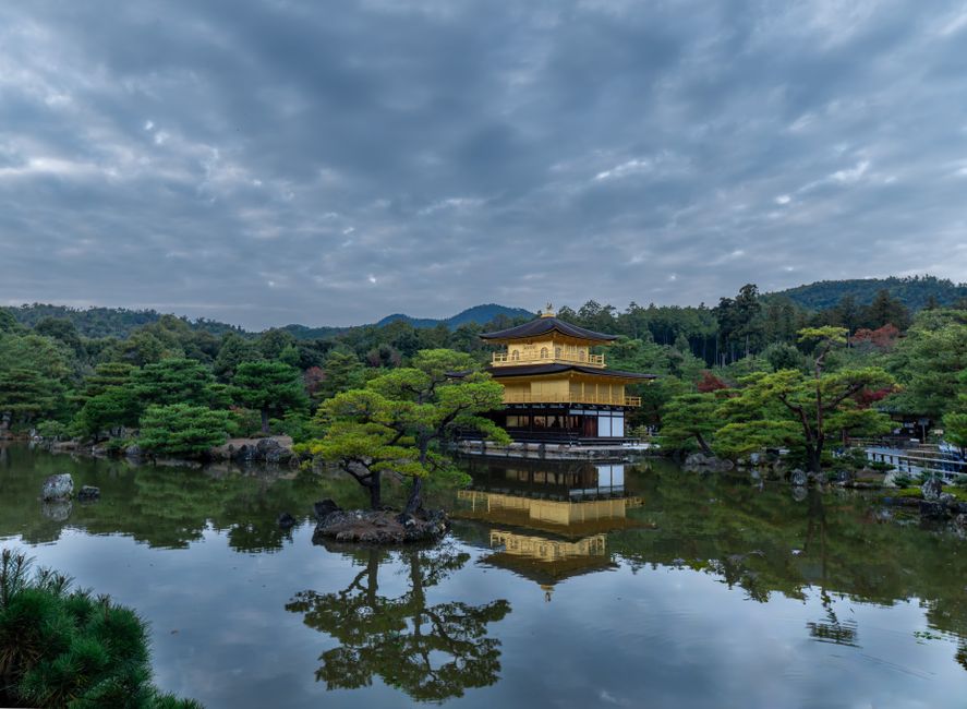 Serene view of Kinkaku-ji temple reflecting in the calm waters, Kyoto.