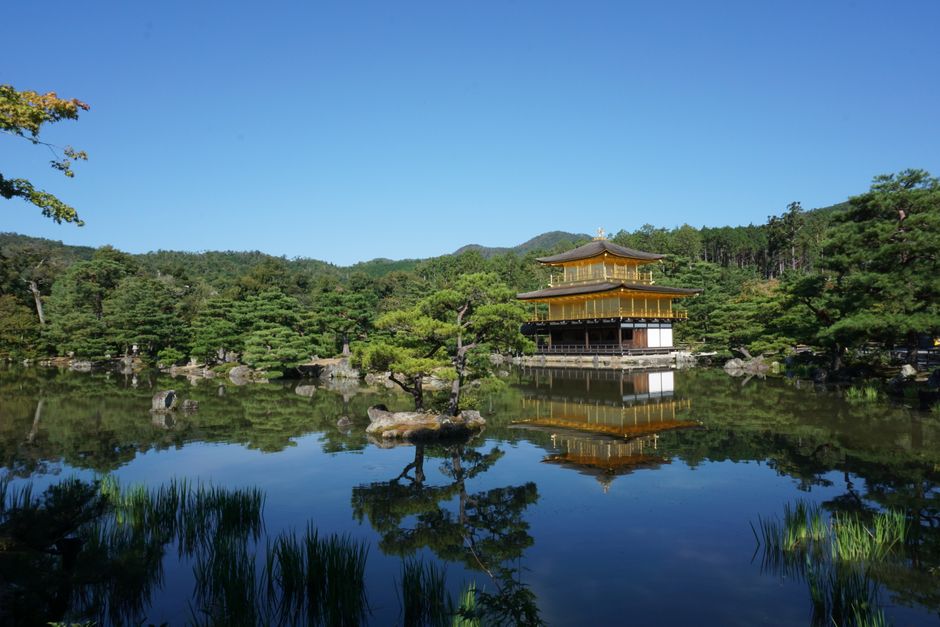Serene view of Kinkaku-ji Temple reflected in a tranquil lake, Kyoto, Japan.
