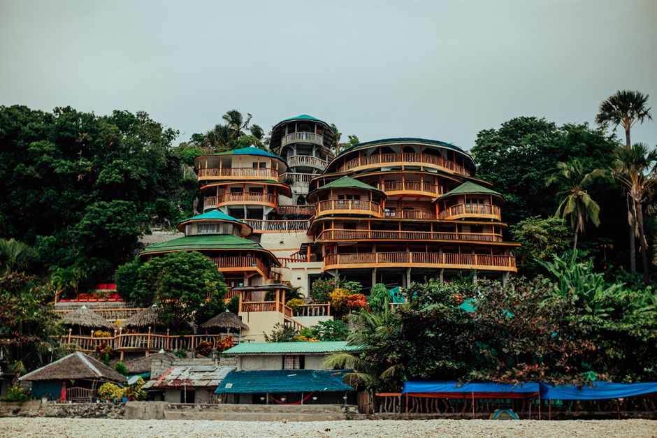 Stunning multi-tiered resort amidst lush greenery on a tropical beach.