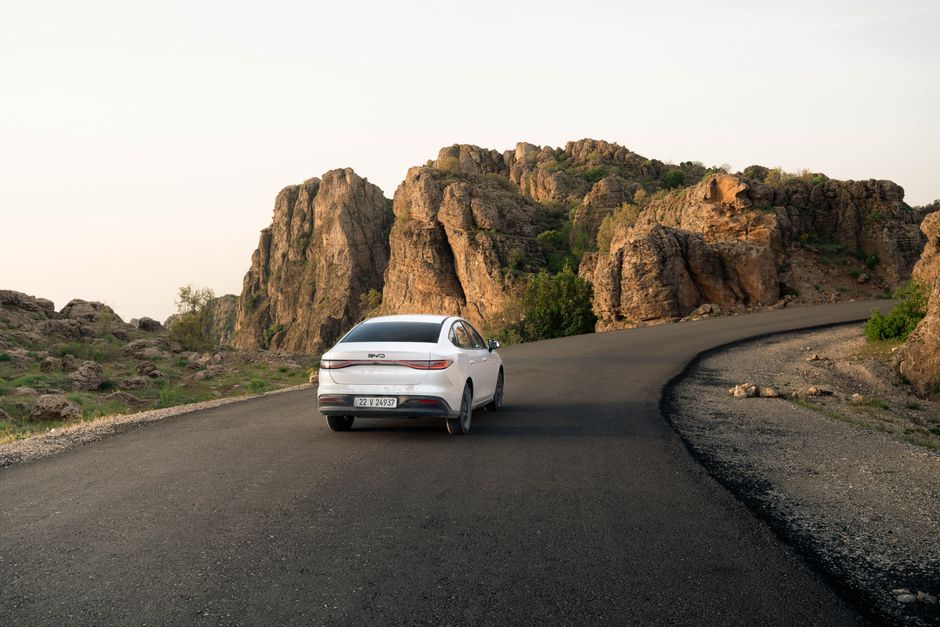 A car travels along a scenic road in Shaqlawa, showcasing the rugged beauty of Iraq's Erbil Governorate.