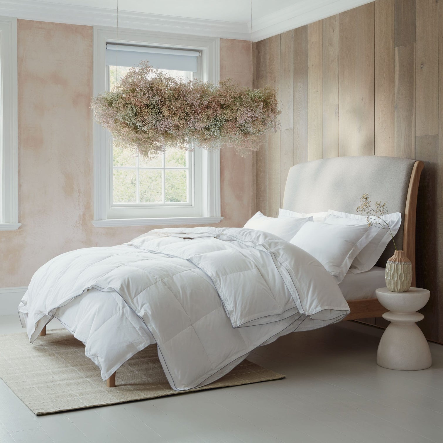 White goose down bedding on a light relaxed bed